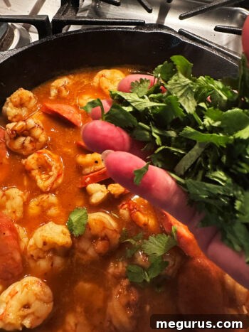 Adding cilantro to the skillet.