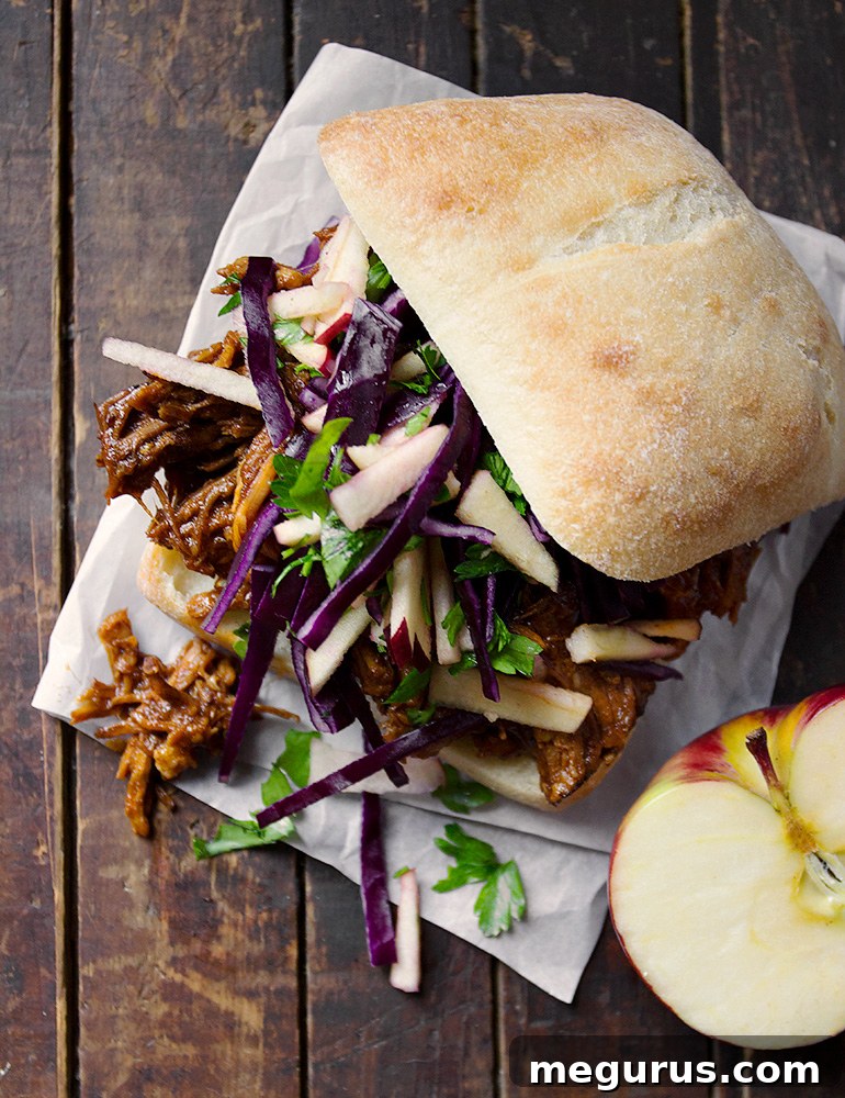Close-up of shredded apple pulled pork with rich sauce