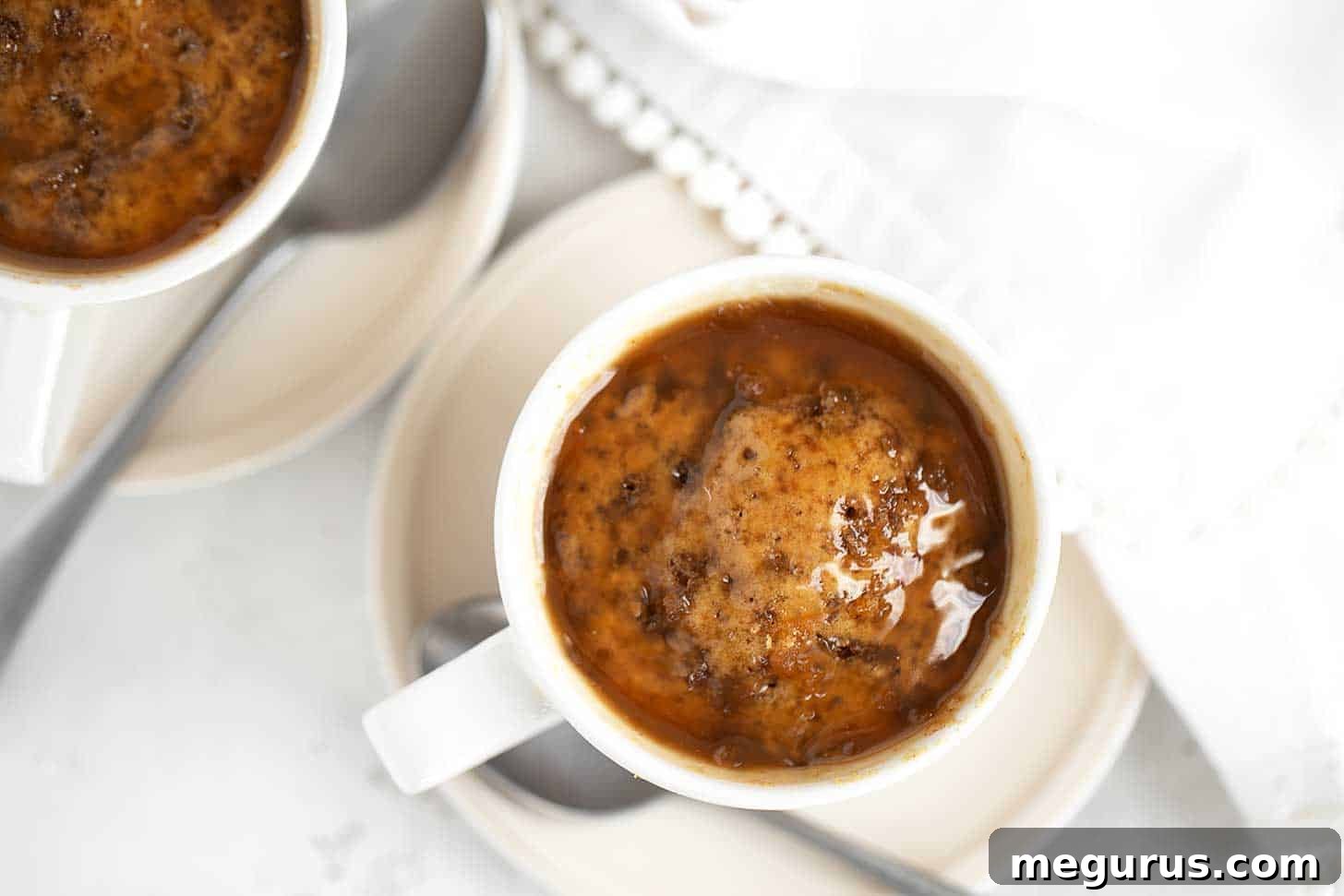 Microwave sticky toffee puddings in coffee cups, drizzled with rich toffee sauce