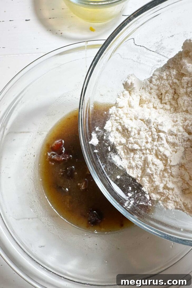 Adding flour, baking powder, and salt to the sticky toffee pudding batter