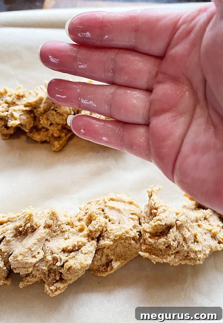 Wetting hands to gently smooth and shape the biscotti dough logs.
