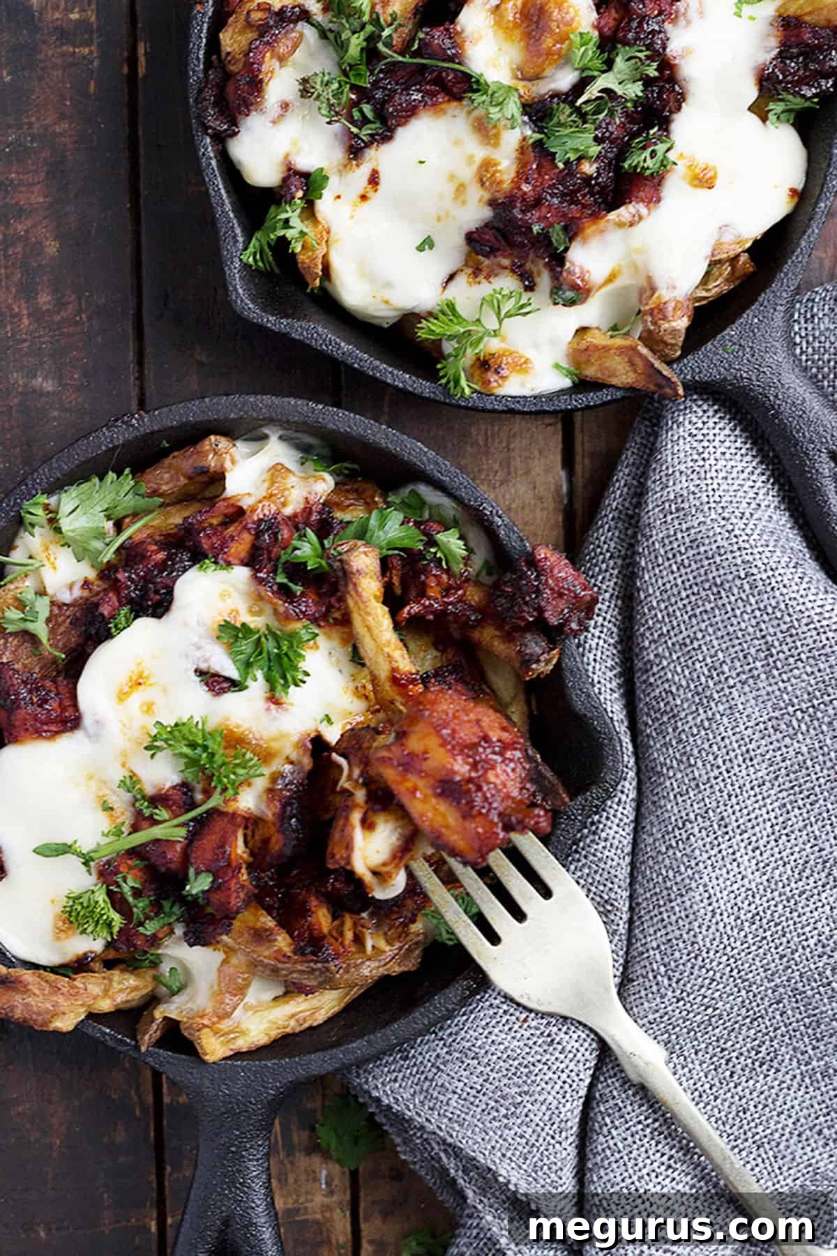 Korean fries with cheese and Fire Chicken in small cast iron skillets, showing multiple individual servings