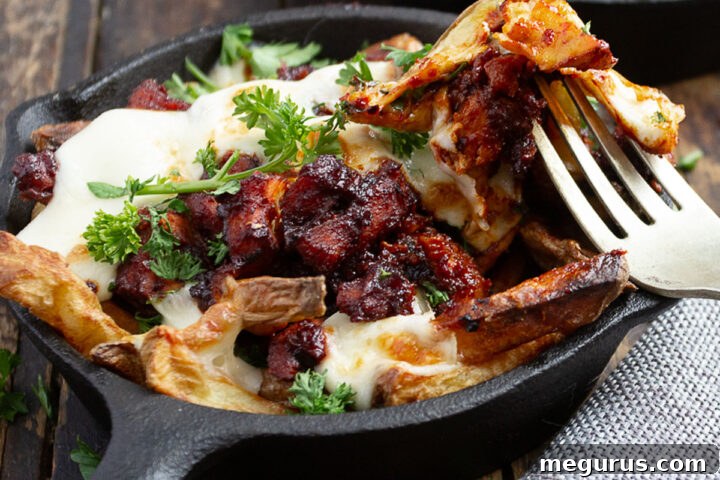 Korean fire chicken cheese fries in small cast iron skillet