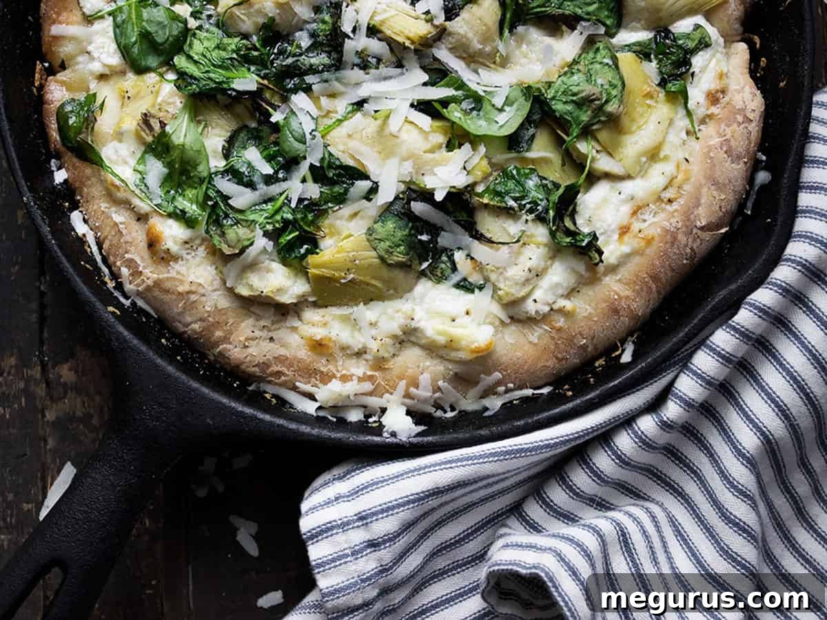 spinach artichoke pizza in skillet