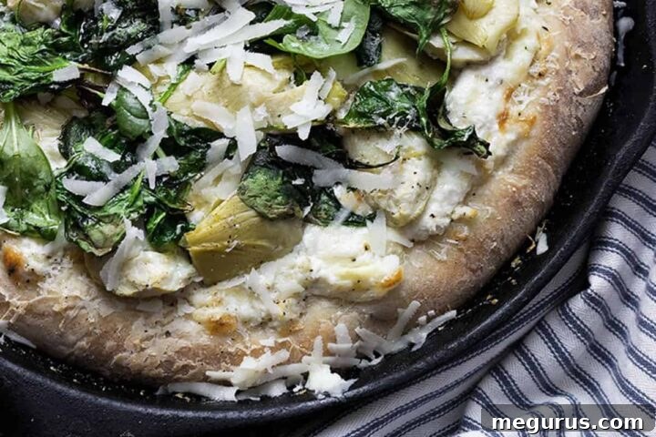 spinach artichoke pizza in skillet