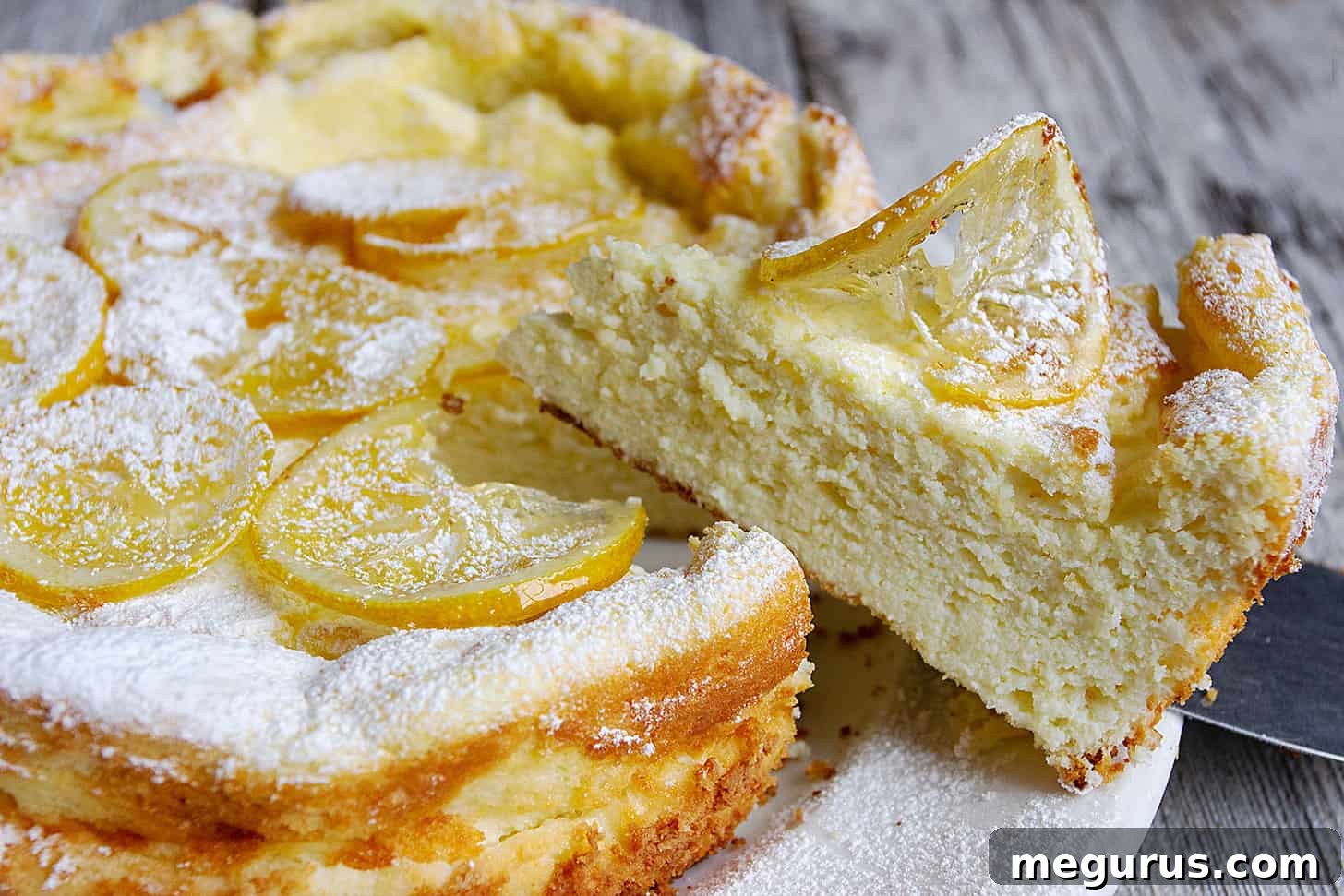 Lemon ricotta cake sliced on a cake plate.