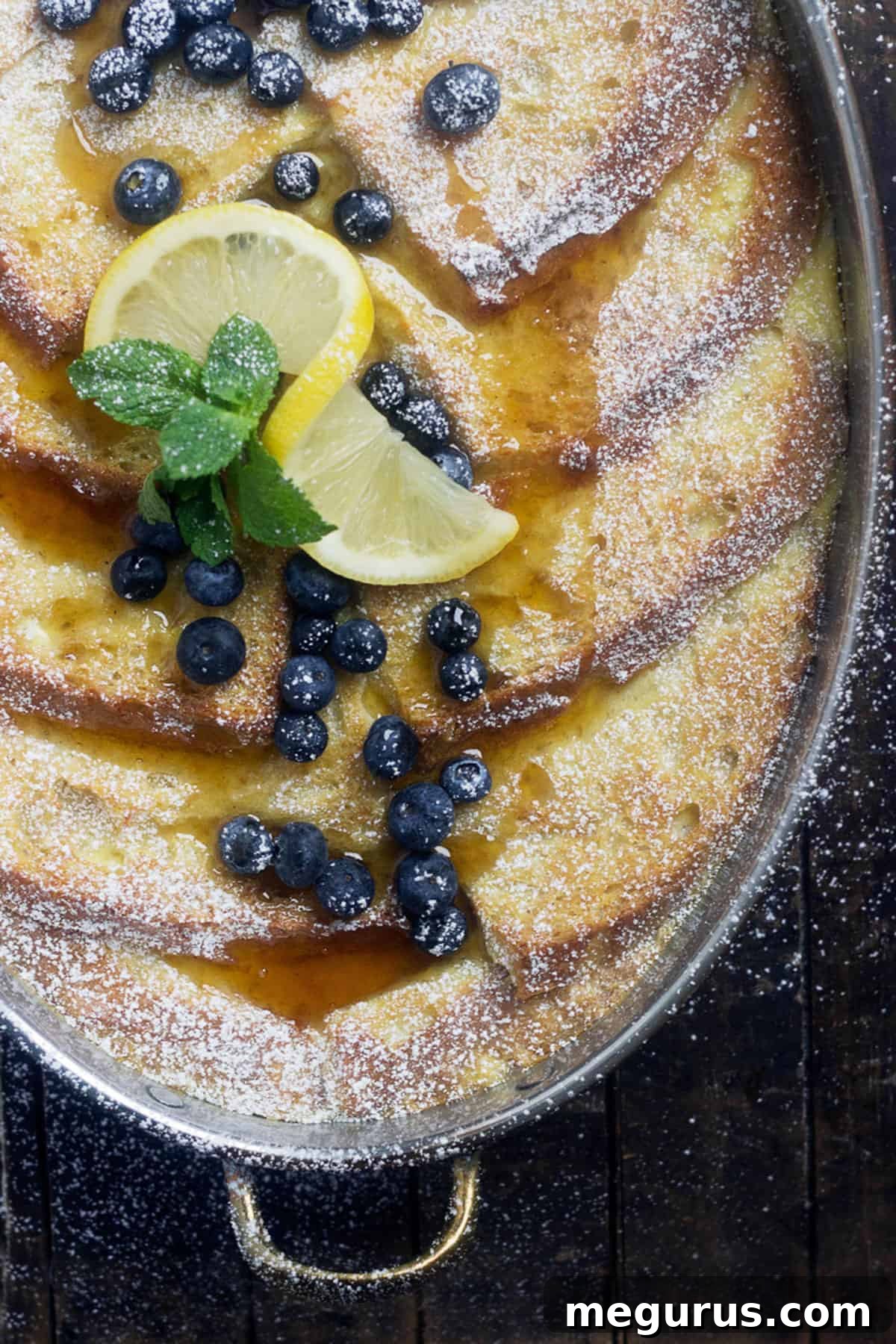lemon French toast in baking dish with blueberries and lemon slices