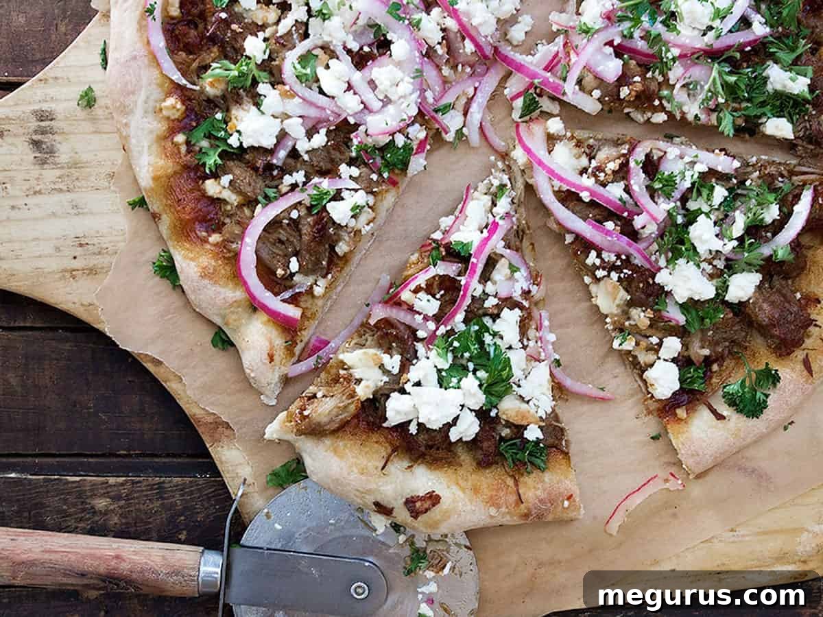 Delicious Carnitas Pizza with Mexican pulled pork and cotija cheese, sliced on a pizza peel.