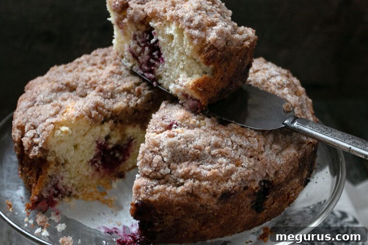 berry crumb cake sliced on cake plate