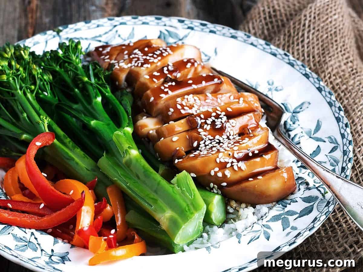 teriyaki chicken breasts on plate with roasted vegetables