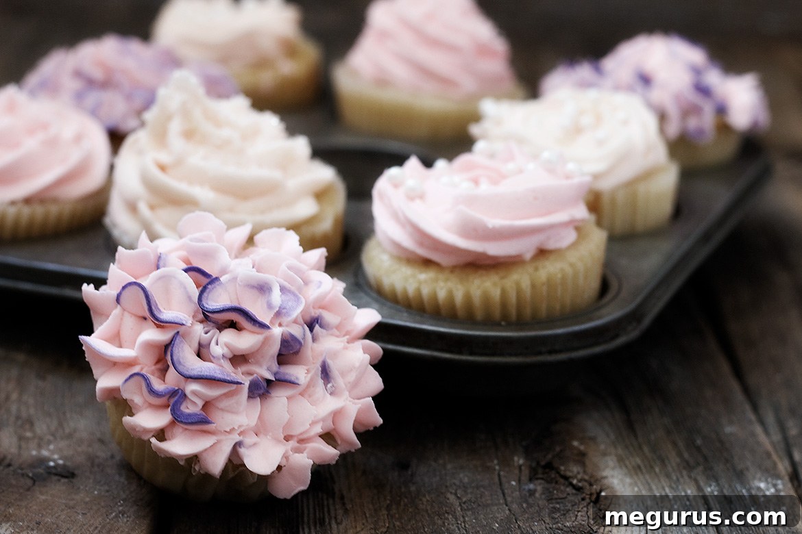 Classic Vanilla Cupcakes topped with elegant white frosting and sprinkles