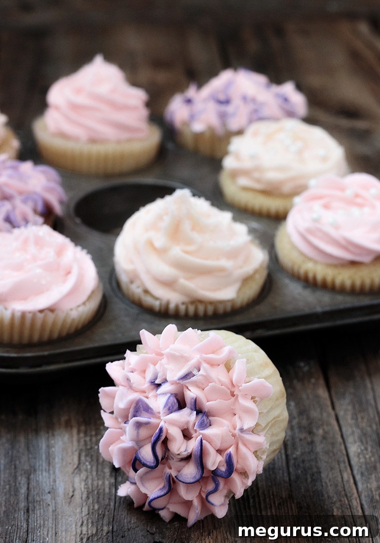 A perfectly piped classic vanilla cupcake with smooth, creamy white frosting