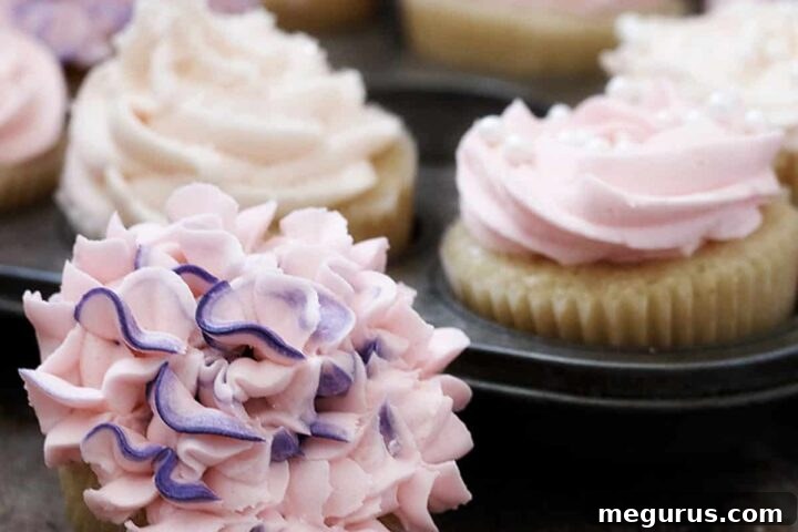 Perfectly baked classic vanilla cupcakes with pink buttercream frosting, ready to serve