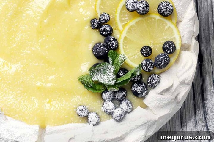 Close-up of Lemon Curd Pavlova with fresh blueberries and mint.