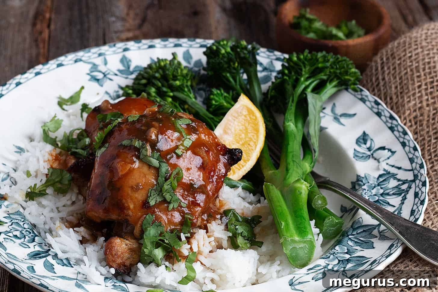 Juicy citrus marinated chicken thighs served on a plate with fluffy rice and vibrant broccolini, showcasing a perfect weeknight meal.