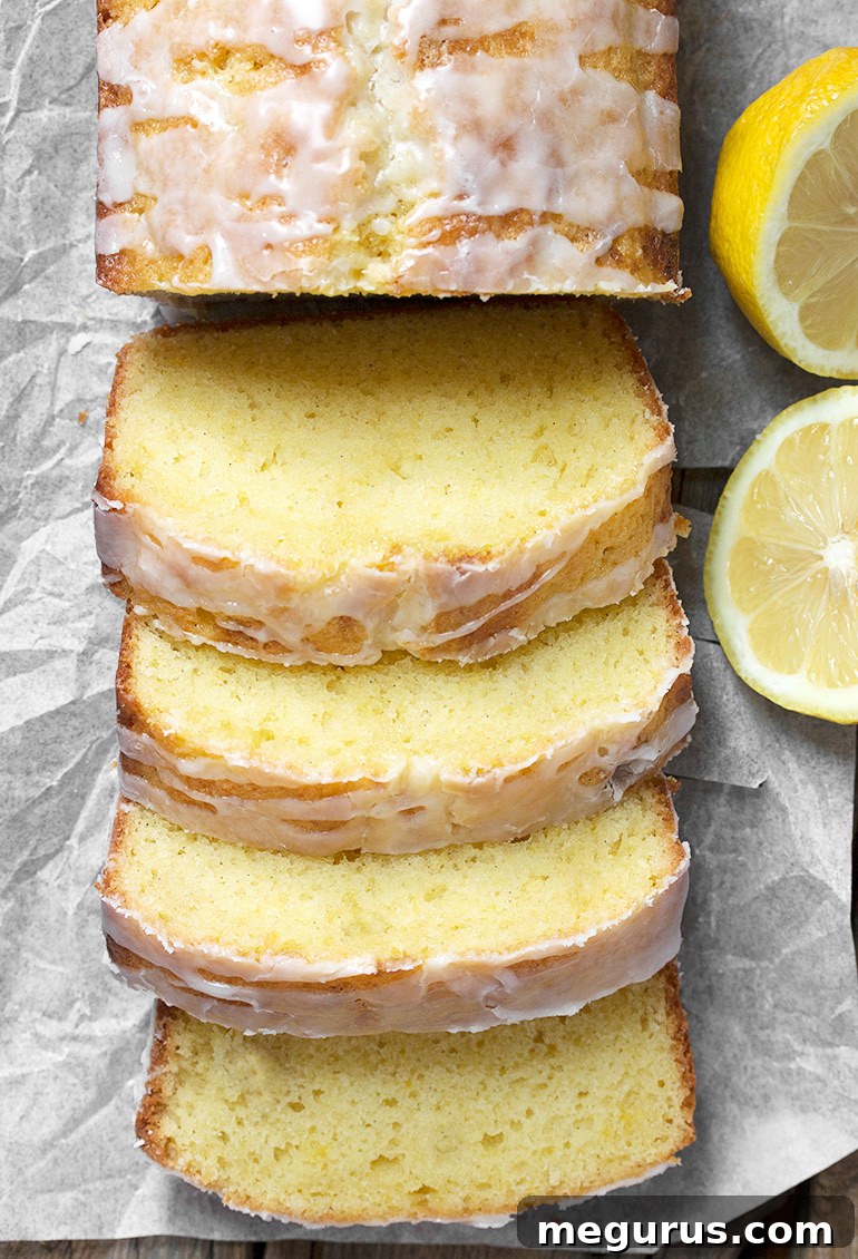 Close-up of a slice of Glazed Lemon Pound Cake Loaf, showing its moist texture and vibrant lemon glaze