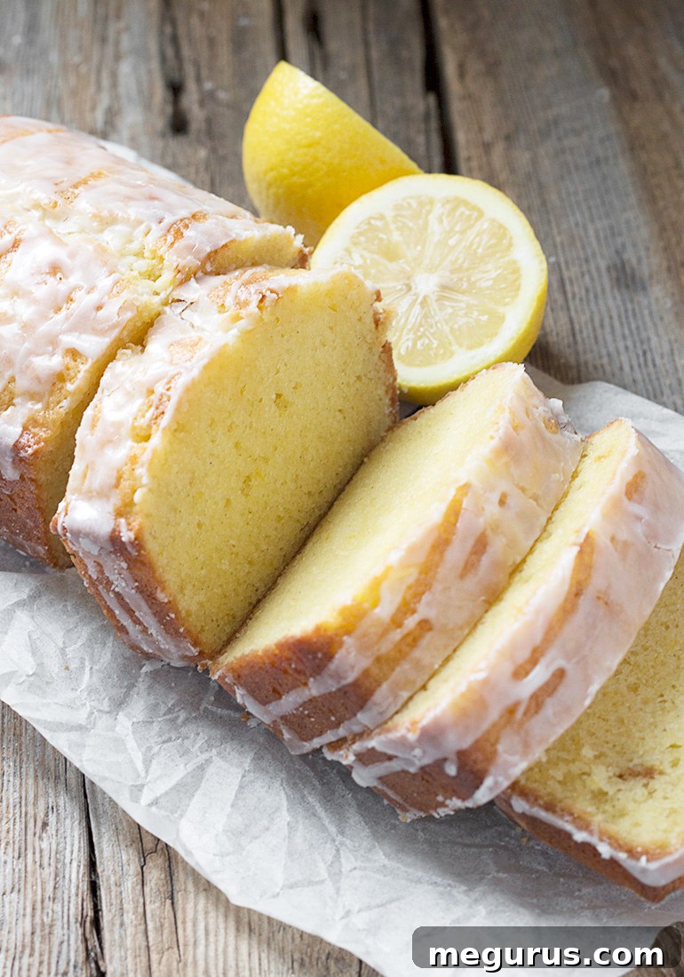 A vibrant lemon half and a whisk, representing the fresh ingredients and the joy of baking this lemon loaf.