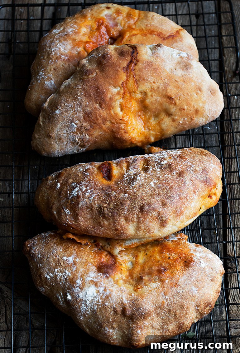 Golden brown, crispy calzones fresh out of the oven, ready to be enjoyed.