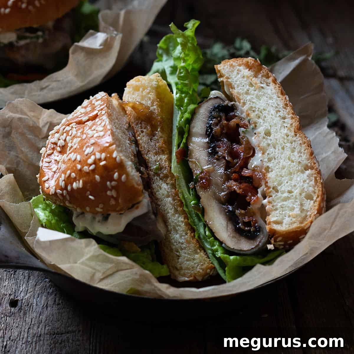 Juicy Portobello mushroom burger stuffed with homemade bacon jam, provolone cheese, and fresh herb mayo, served on a toasted bun on a rustic platter