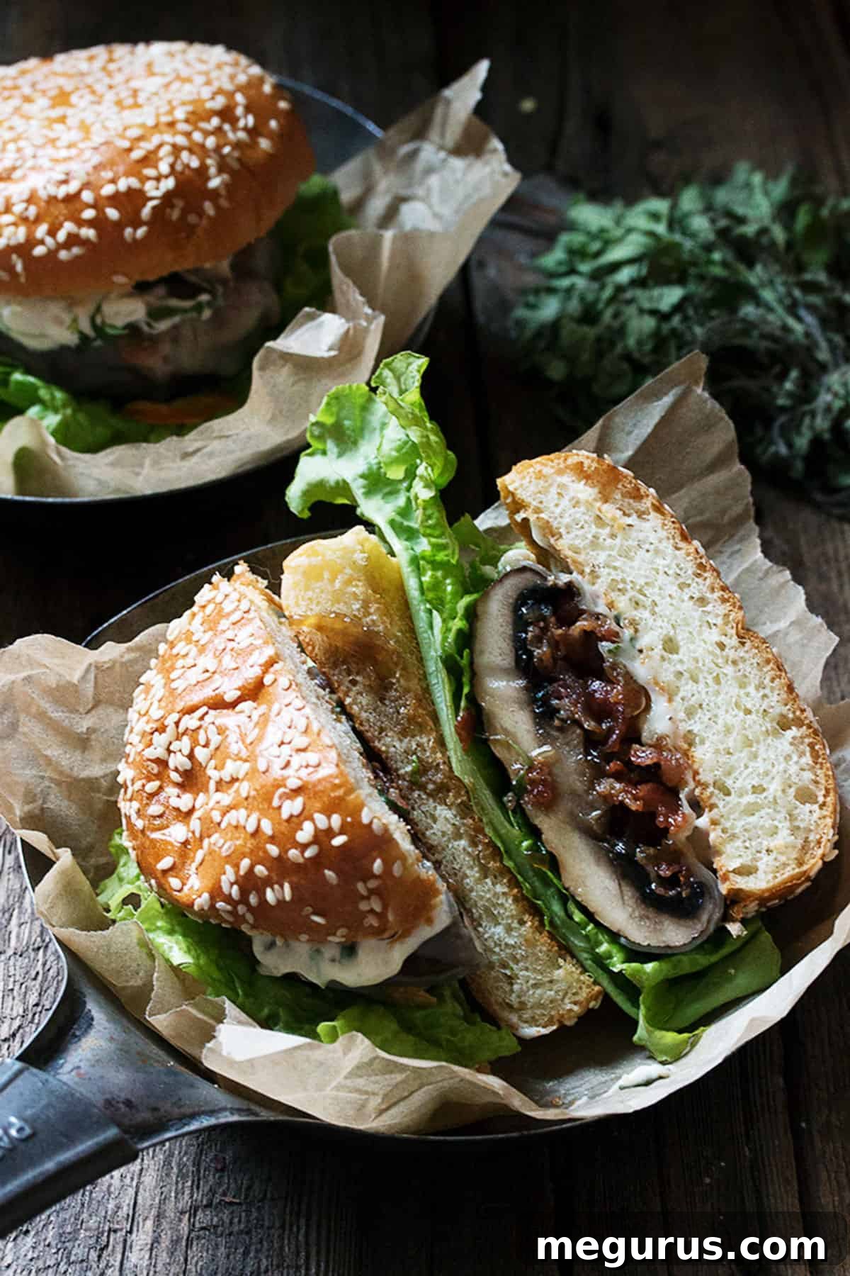 Close-up of bacon jam filled portobello mushroom burgers, topped with provolone cheese, sizzling in a cast iron skillet, ready to be placed on buns