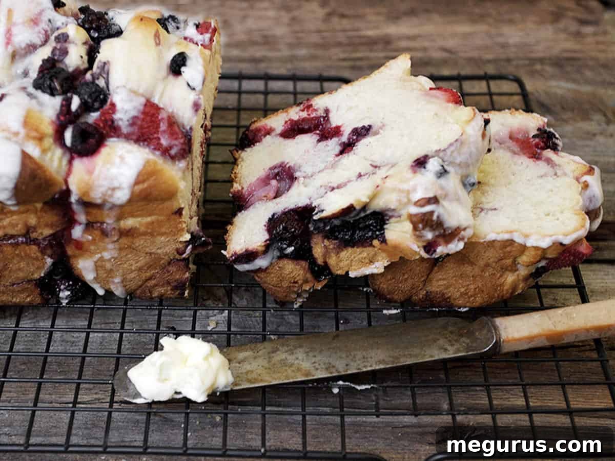 Sliced Glazed Summer Fruit Yeast Bread on a cooling rack