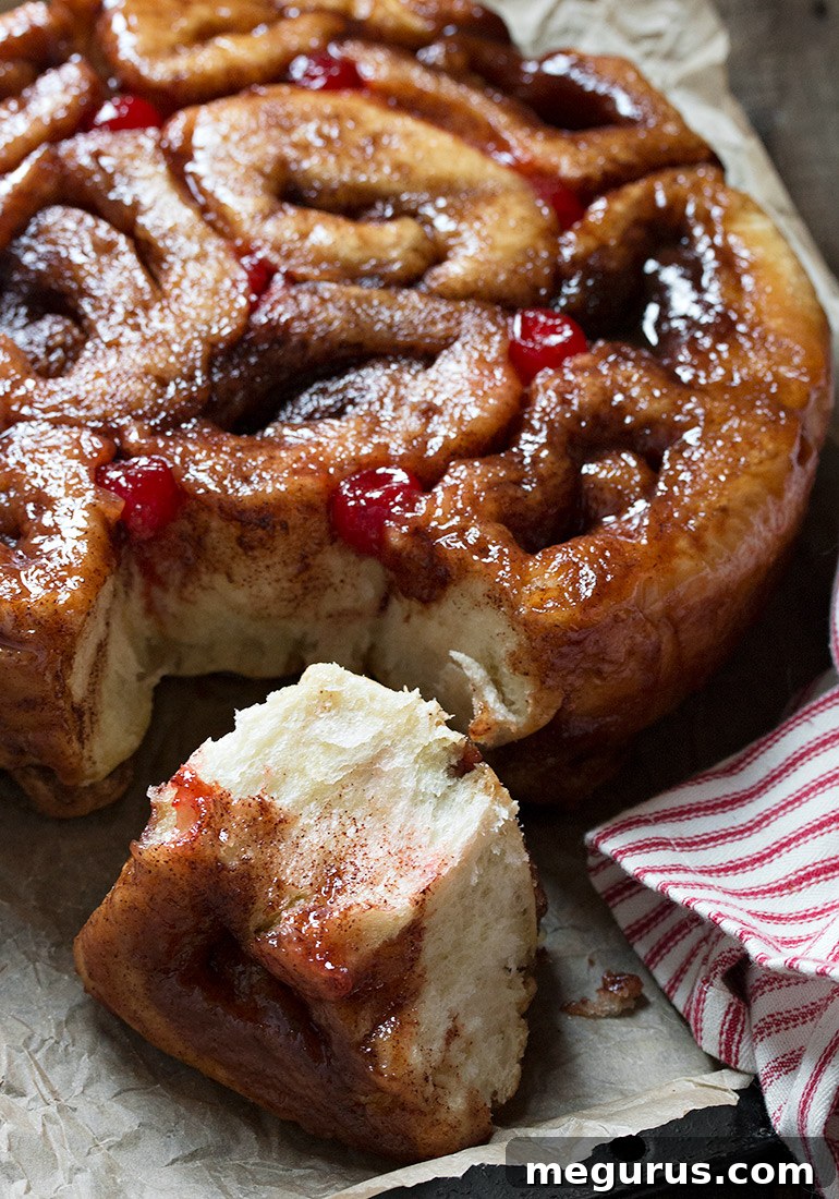 A cluster of freshly baked Muskoka Chelsea Buns pulled apart, revealing the cinnamon swirl