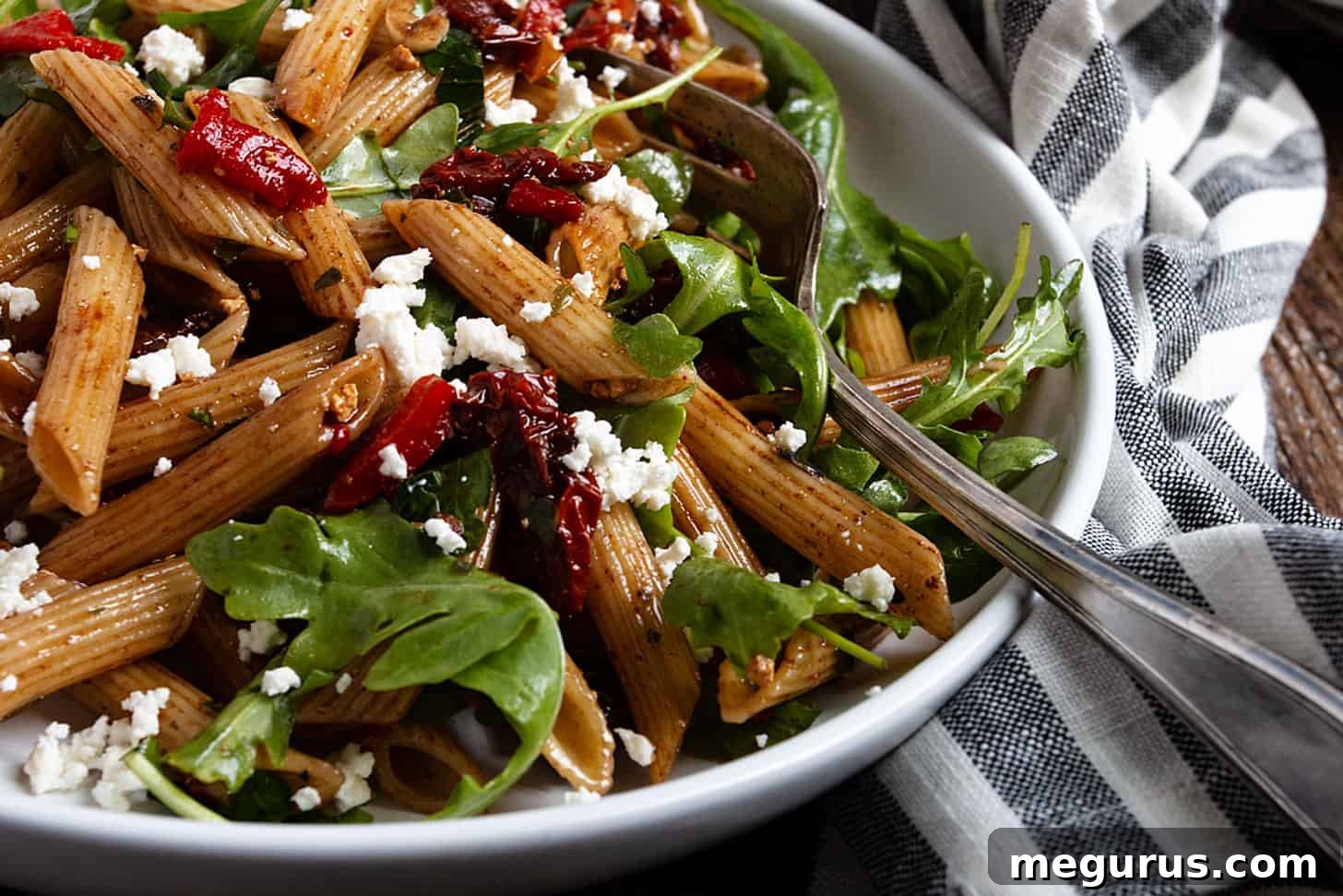 Italian pasta salad in bowl with fork, ready to be served