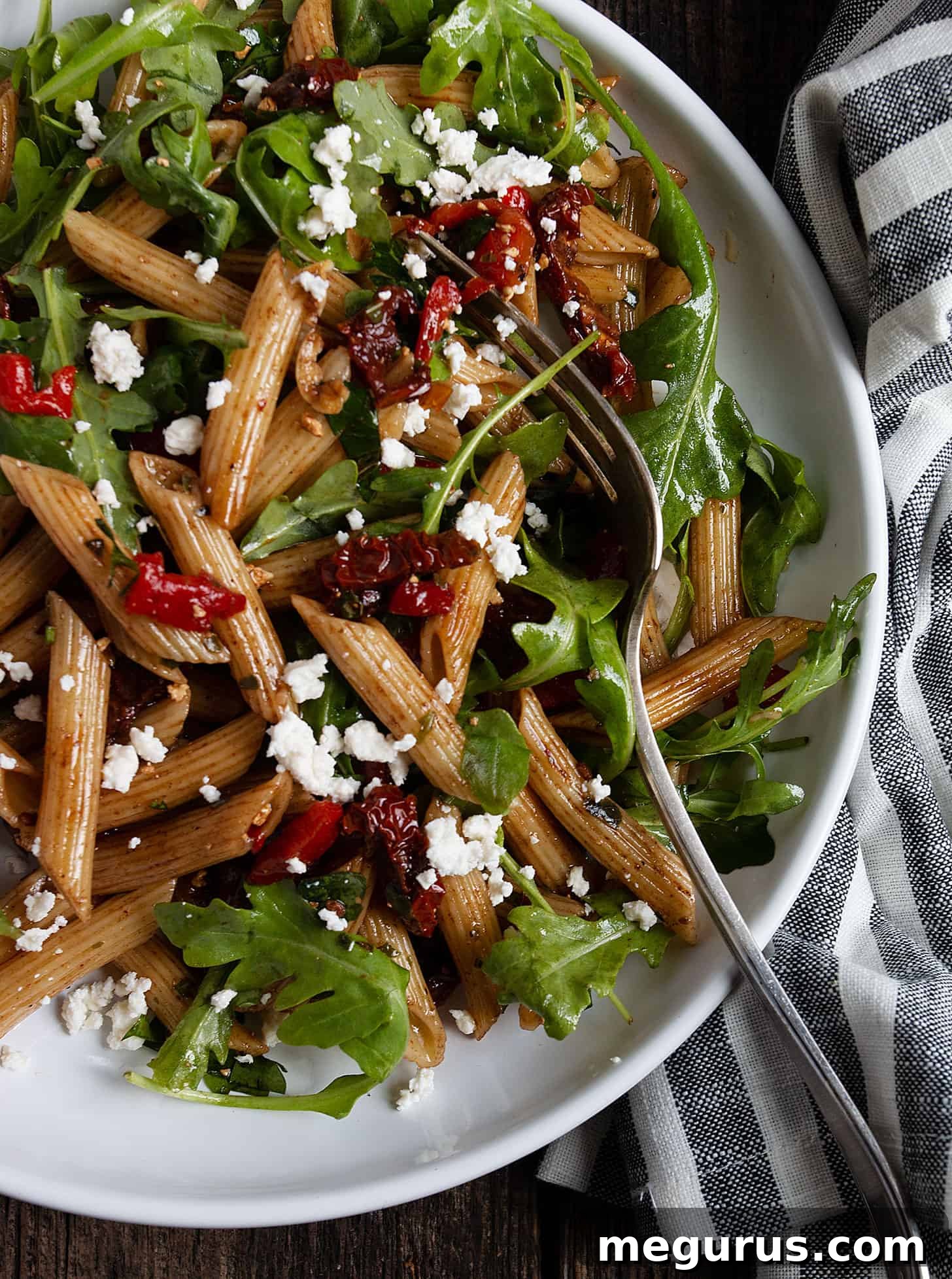 Italian pasta salad with a serving fork, showing texture and ingredients