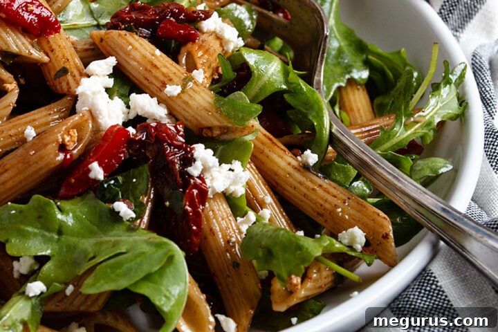 Italian pasta salad in bowl with fork