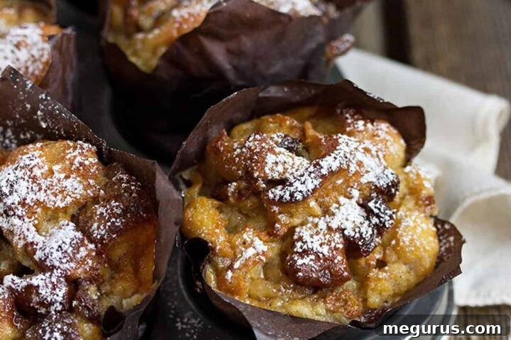 Freshly baked bread pudding muffins cooling in a muffin pan