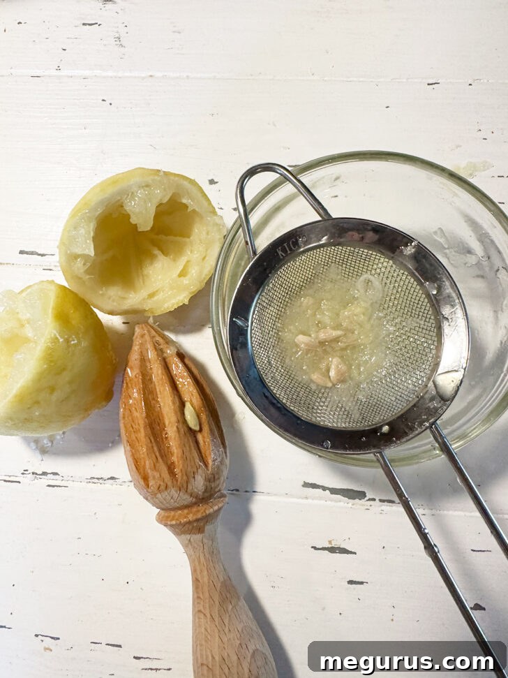 The boiled lemon being cut and juiced into a small bowl.