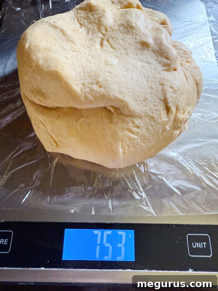 Weighing the entire dough ball on a digital kitchen scale.