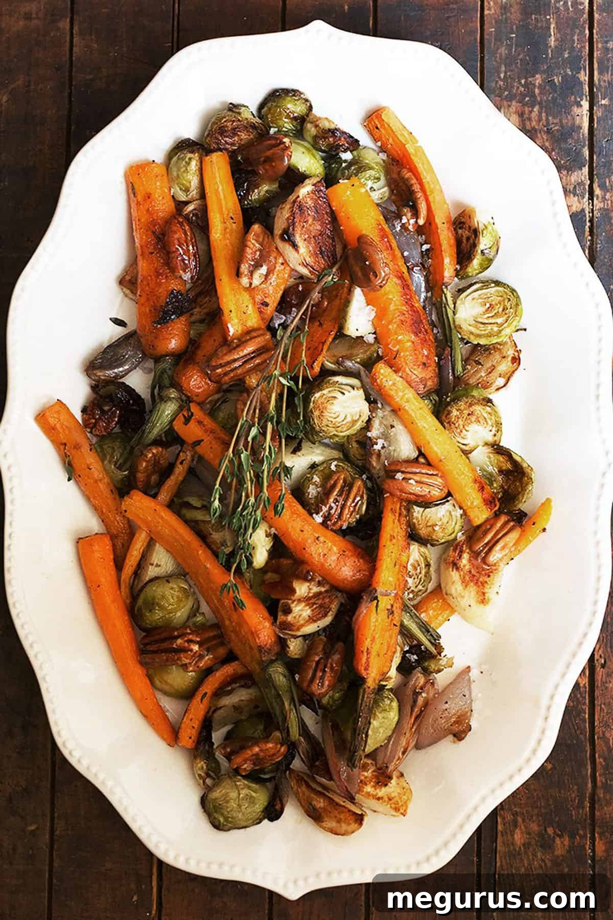 maple roasted vegetables with maple pecans on white plate