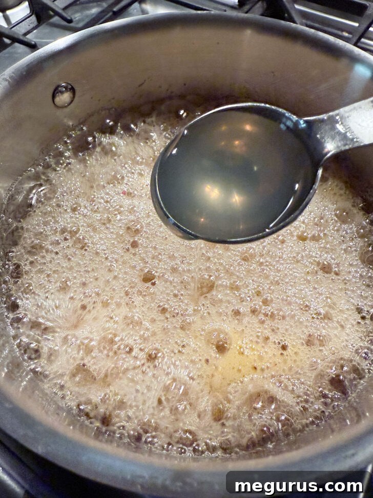 Adding optional liquid pectin to the hot jelly at the end of the cooking process.