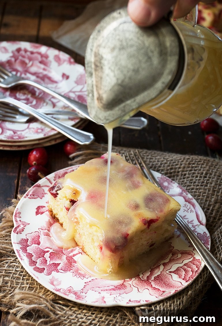 Slice of Cranberry Cake with Vanilla Sauce, ready to be served