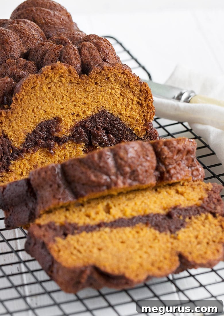 Beautifully sliced pumpkin chocolate swirl bread arranged on a cooling rack, ready to be enjoyed or stored.