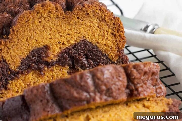 Homemade Pumpkin Chocolate Swirl Bread, a delicious fall treat with a rich brownie swirl.