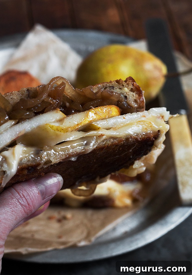 A freshly made Pear, Gouda and Balsamic Onion Grilled Cheese, cut in half