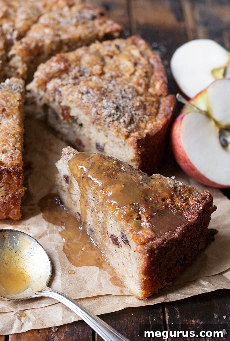 Sliced Apple Hazelnut Cake with Toffee Sauce on a white plate