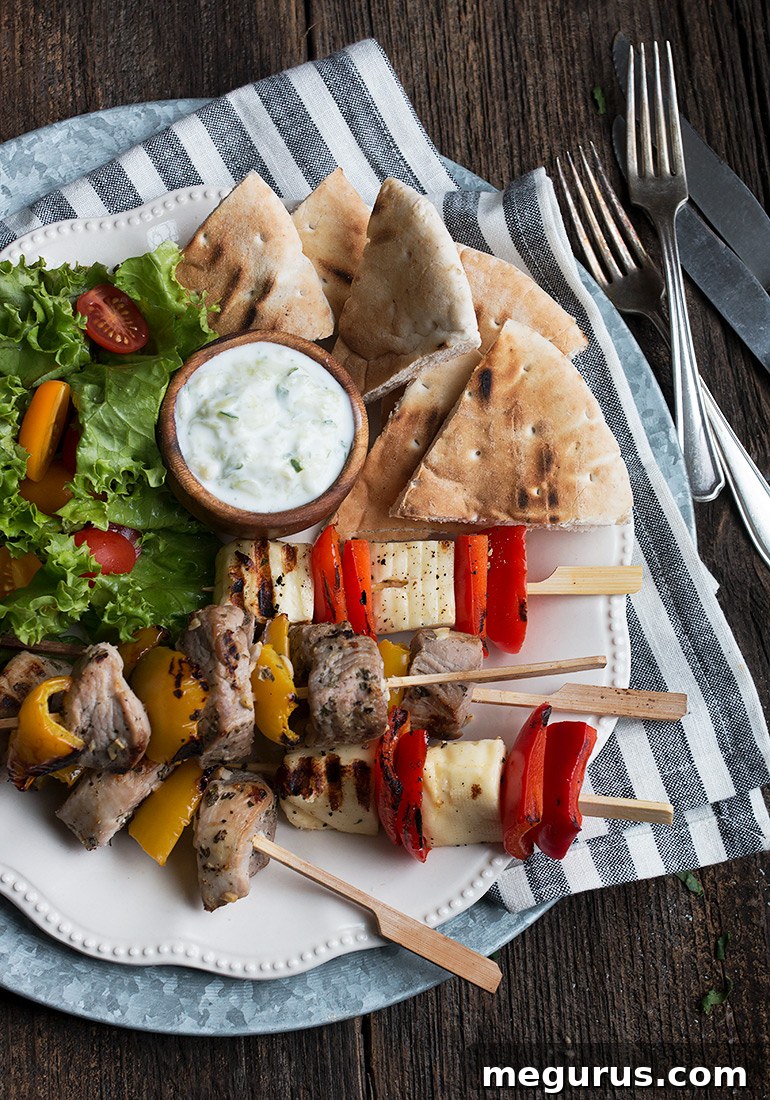 Close-up of grilled pork souvlaki and Halloumi pepper skewers