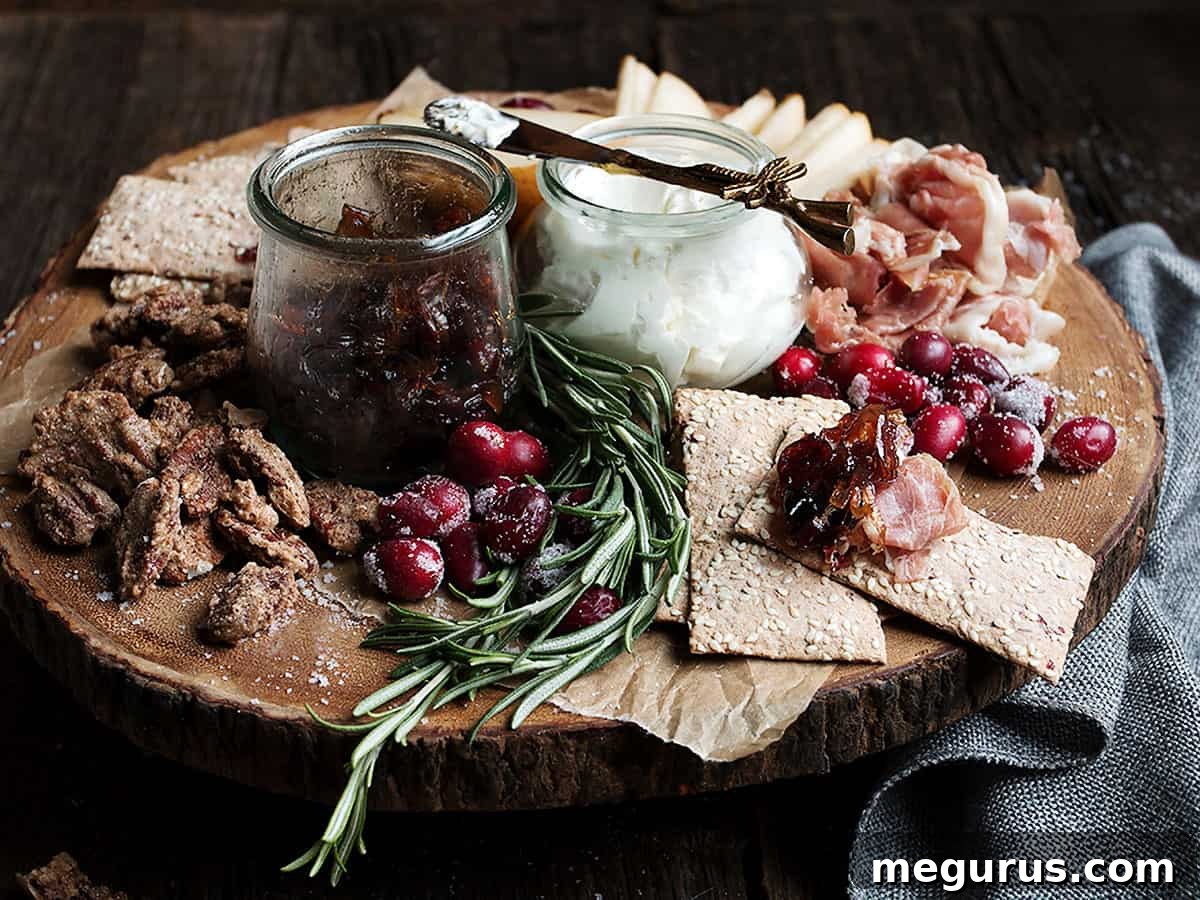 cranberry charcuterie platter on wooden round board, showcasing various festive ingredients