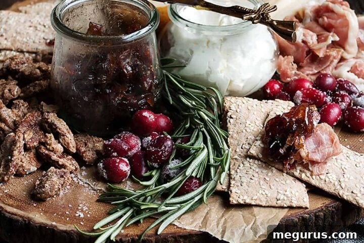 cranberry charcuterie platter on wooden round board, garnished beautifully