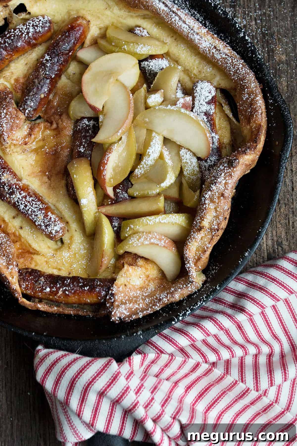Sausage and apple Dutch baby in cast iron skillet
