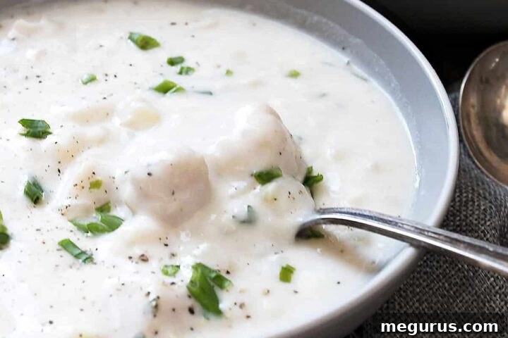 Thick and creamy seafood chowder in a bowl with a spoon, ready to serve