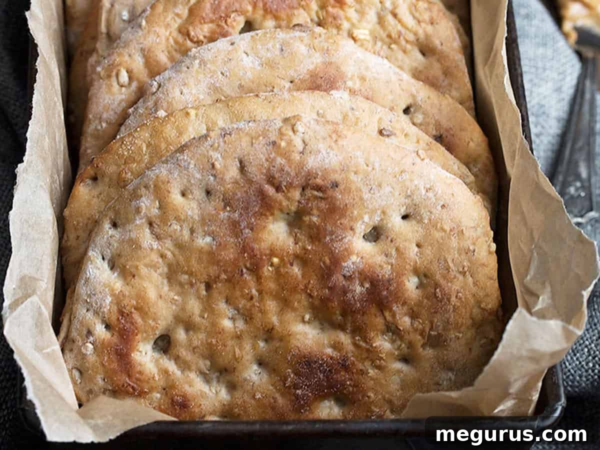 Homemade Banana Walnut Multigrain Breakfast Rounds in a loaf pan, freshly baked and golden brown.