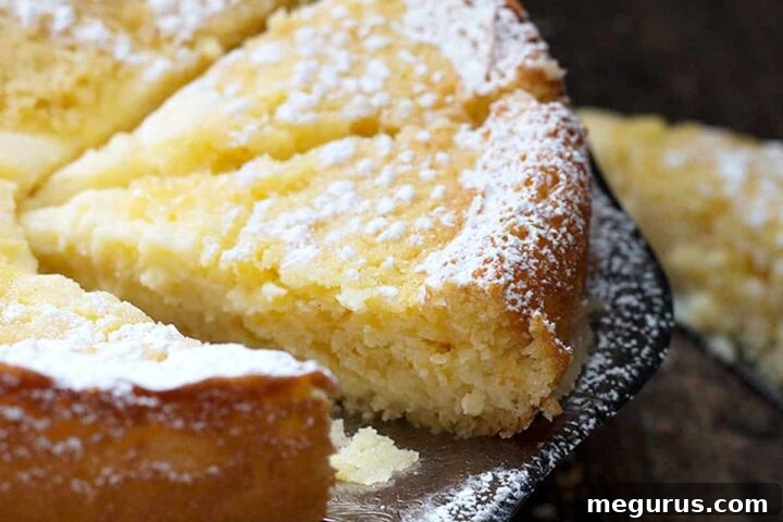 A slice of Lemon Cream Butter Cake with a creamy center and golden edges