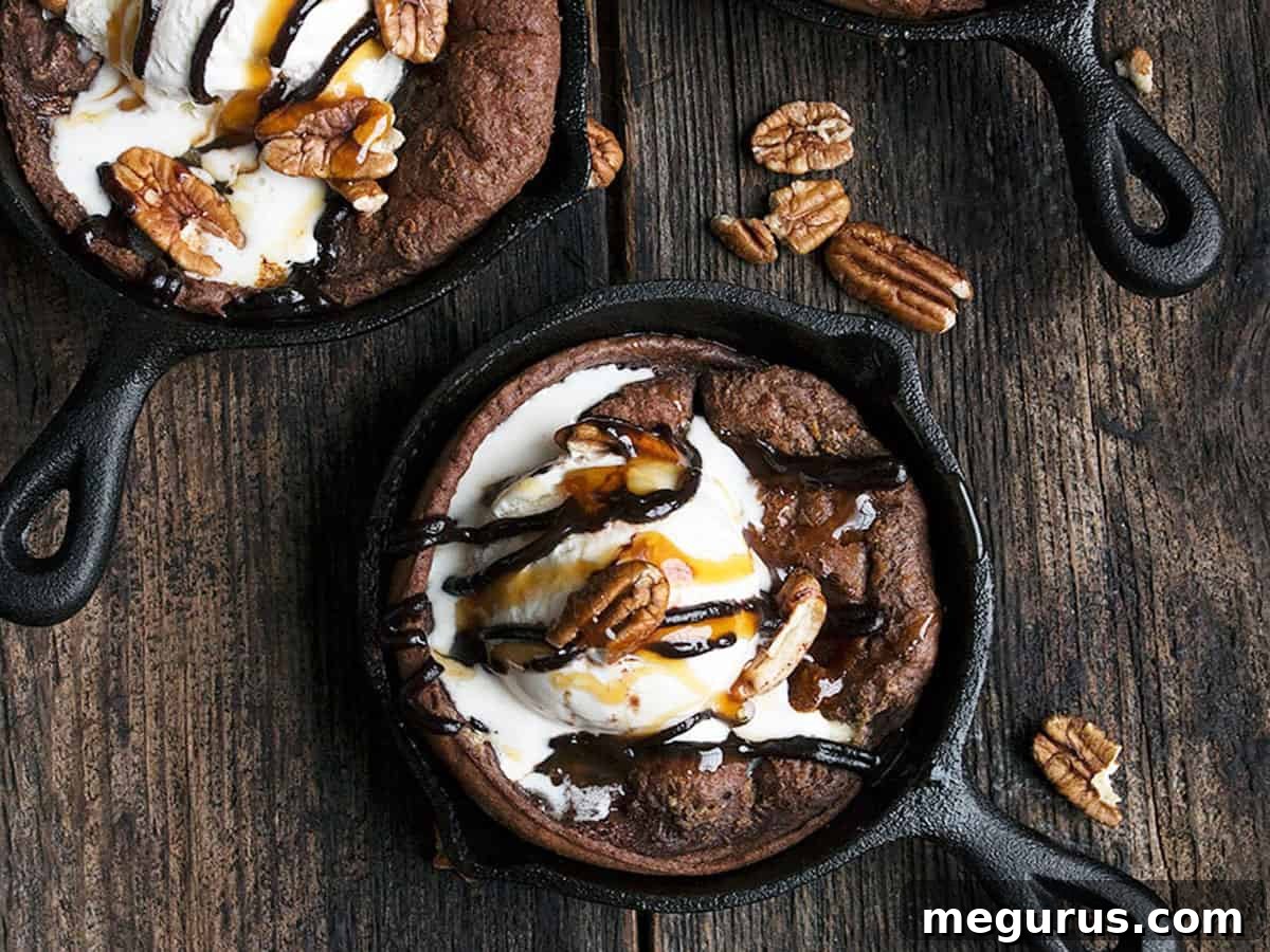 Puffy chocolate Dutch babies in mini cast iron skillets, ready to be topped