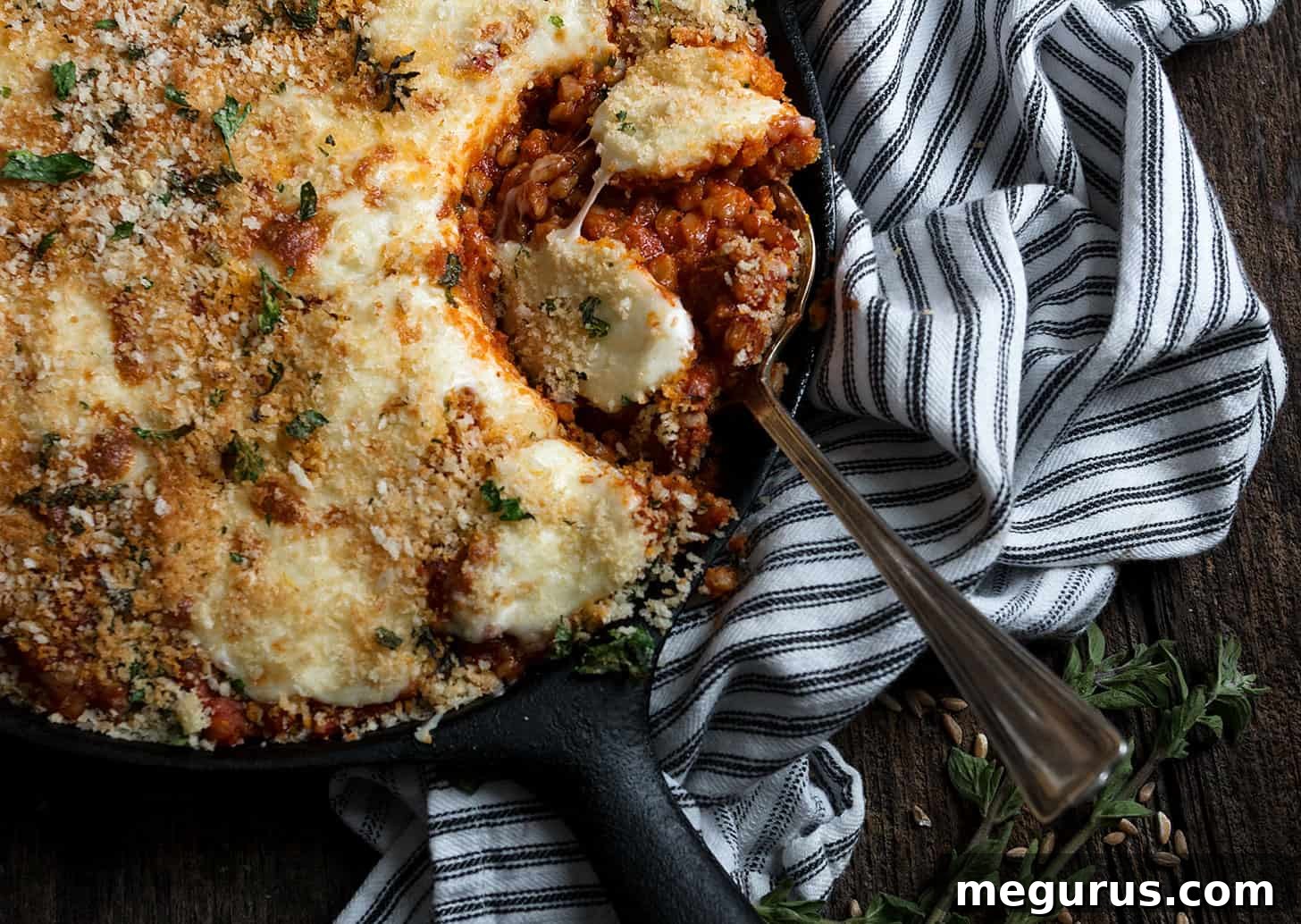 Sausage and Farro Parmesan in a skillet, ready to serve
