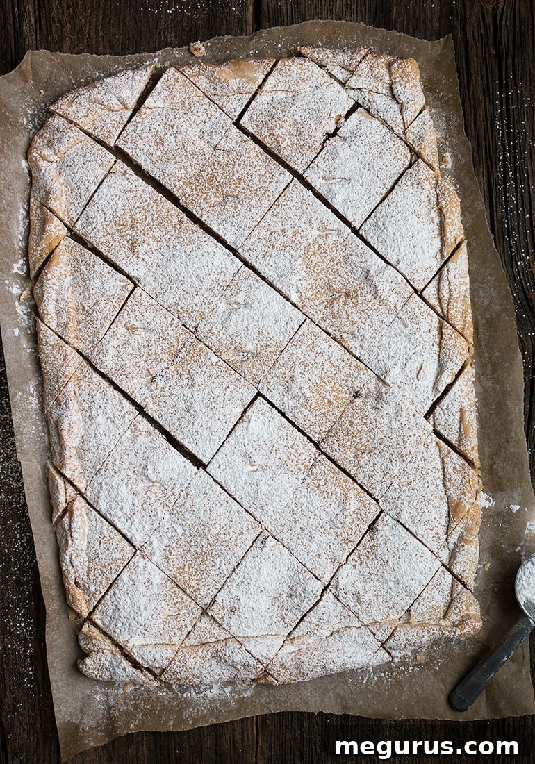 Close-up of baked Raspberry Jam Squares, showcasing the jam filling and golden crust