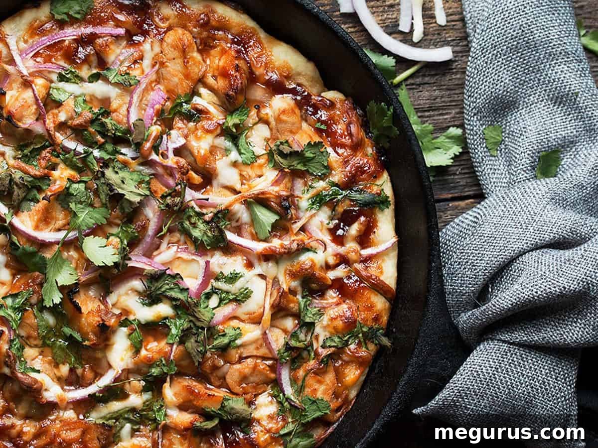 Delicious BBQ Chicken Skillet Pizza cooking in a cast iron pan